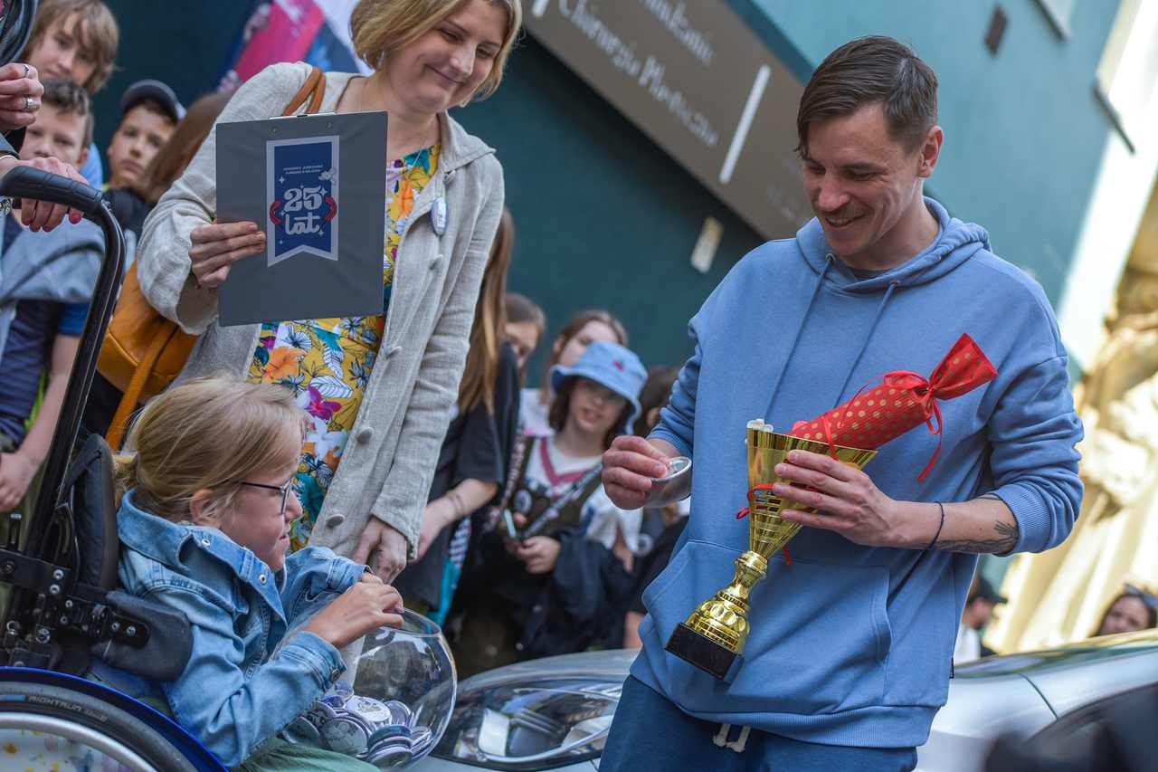 Twórca muralu Gajusza, Bruno Neuhamer odbiera podziękowanie od podopiecznej fundacji